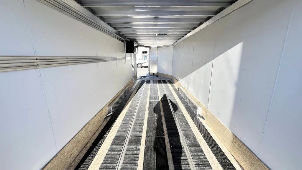 2024 Sno Pro 22 ft Snowmobile Trailer – Extra Height – View from the rear looking forward through the open interior workspace