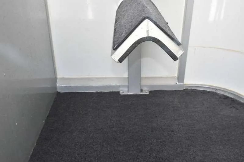 2002 Kiefer Built 2 Horse Bumper Pull – Dressing Room – Detail of floor mat and a mounting post inside the trailer