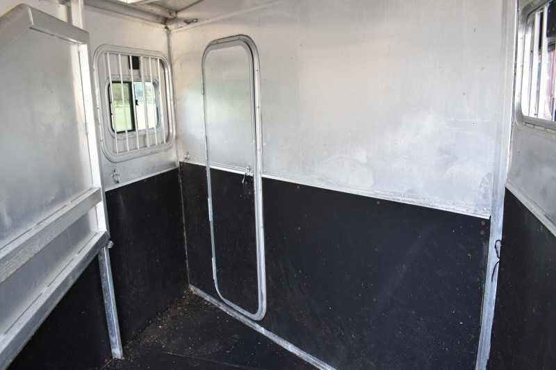 2002 Exiss SS20 2 Horse Trailer – Walk-Through Dressing Room – Inside the horse area showing metal walls and black rubber kick mats