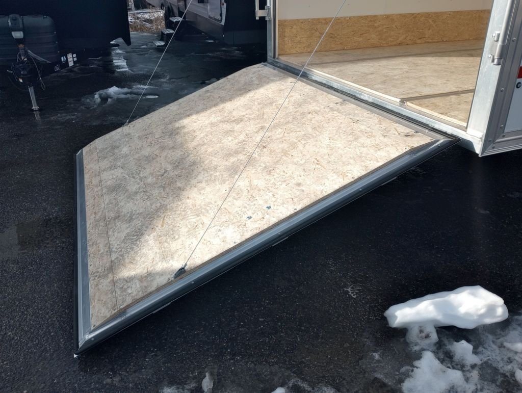 2024 Mission Trailers 24 ft Deckover – Galvanized Package – Close-up of the front ramp door extended showing the transition and cables