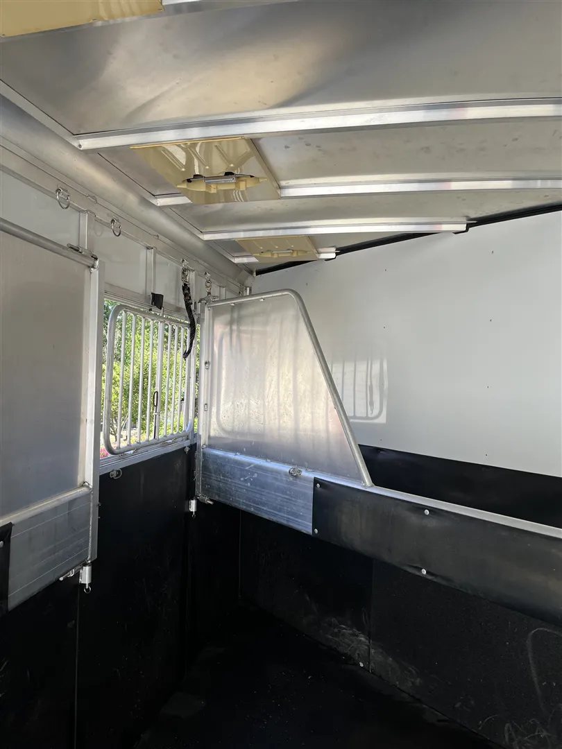 2013 Sundowner Sportsman 3 Horse Trailer – Extra-Large Tack Room – View of the horse stalls from inside with aluminum dividers and roof vents