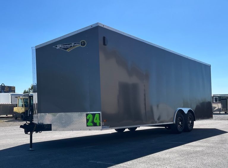 2026 Millennium 24 ft Car Hauler – Charcoal Hero – Exterior three-quarter profile of a grey enclosed car hauler trailer with aluminum wheels