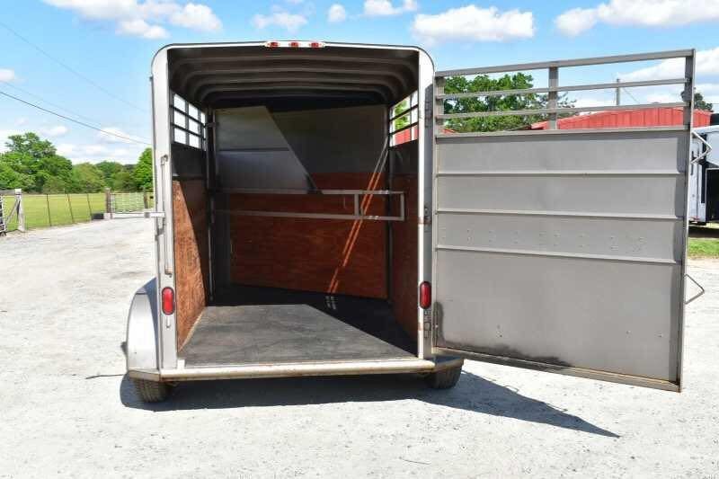 2010 Calico 2 Horse Trailer – Steel, Walk-In Dressing Room – Rear view of the trailer with the back gate wide open revealing the interior