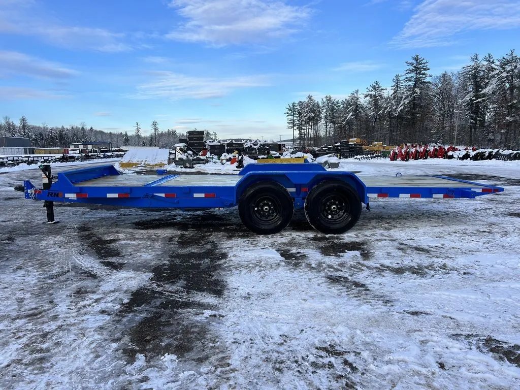 2024 Rice Trailers 20 ft Tilt Trailer – Spare Mount – Full side profile of the blue flatbed trailer parked on a snowy surface