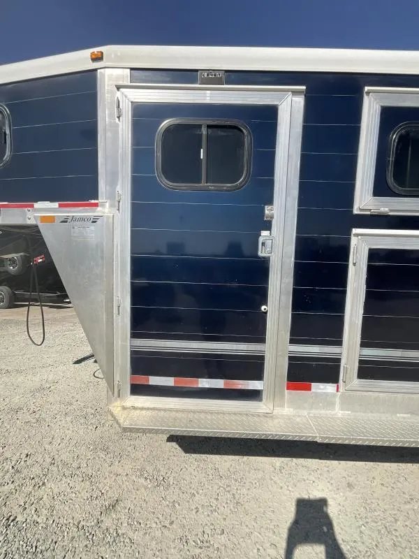 2005 Jamco 4 Horse Gooseneck Trailer – Blue, Air Suspension – Exterior view of the side entry door to the tack room