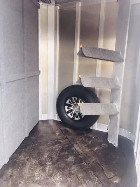 2018 Platinum Coach 3 Horse Bumper Pull – Rear Tack – Floor level view of the tack room storage area and saddle mounts