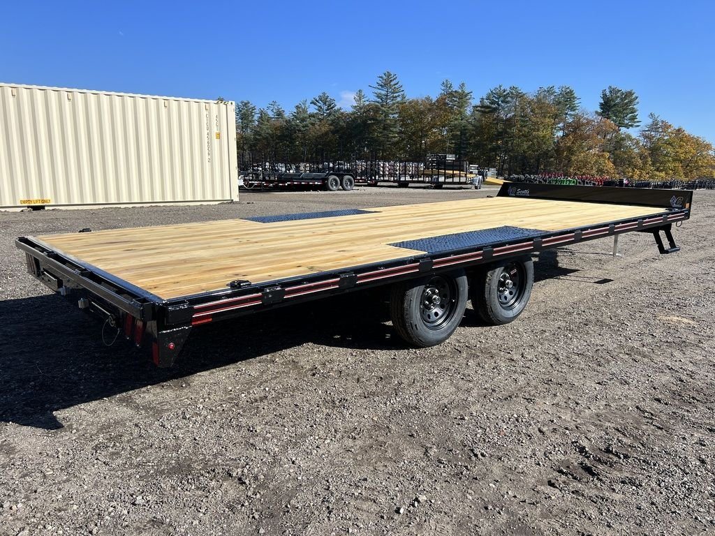2024 Diamond C 20 ft Deckover – Slide-In Ramps – Rear three-quarter view showing the wood deck and black frame of the trailer