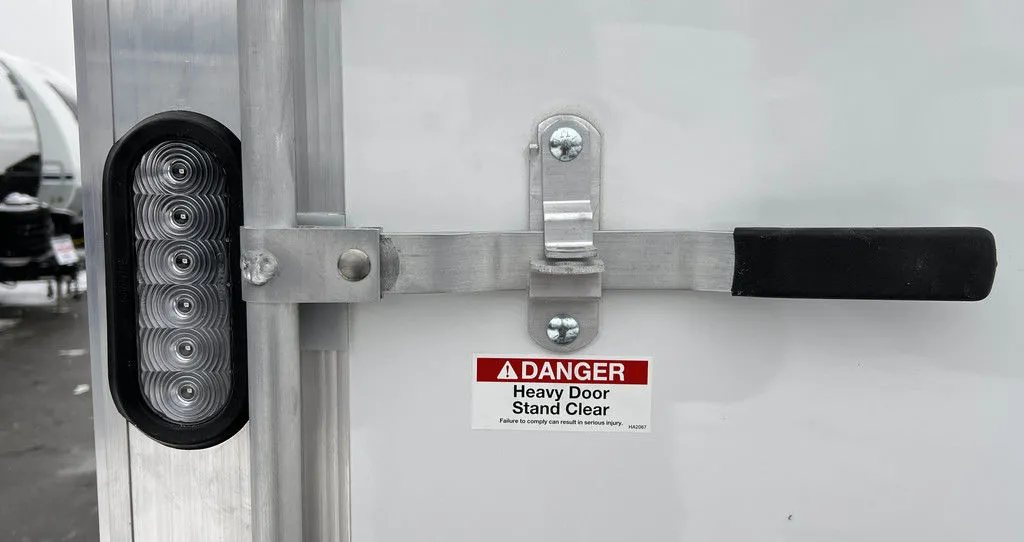 2024 E-Z Hauler 24 ft Trailer – Rear Canopy – Close-up of a vertical LED light strip and a locking door bar handle