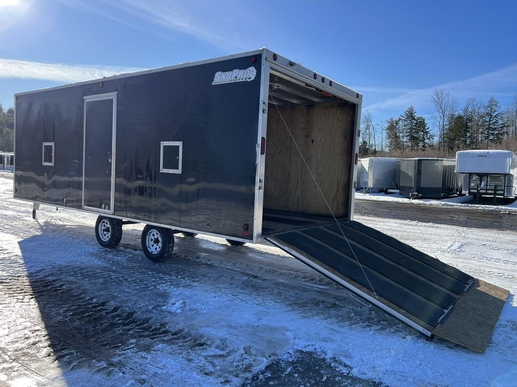 2008 Sno Pro 4-Place Snowmobile Trailer – Black Aluminum – The rear ramp door is lowered to the ground for access