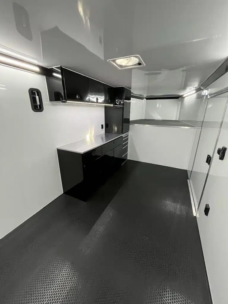 2026 ATC 44 ft Car Trailer – Aluminum Wheels – Clean white trailer interior featuring black cabinetry and a silver countertop