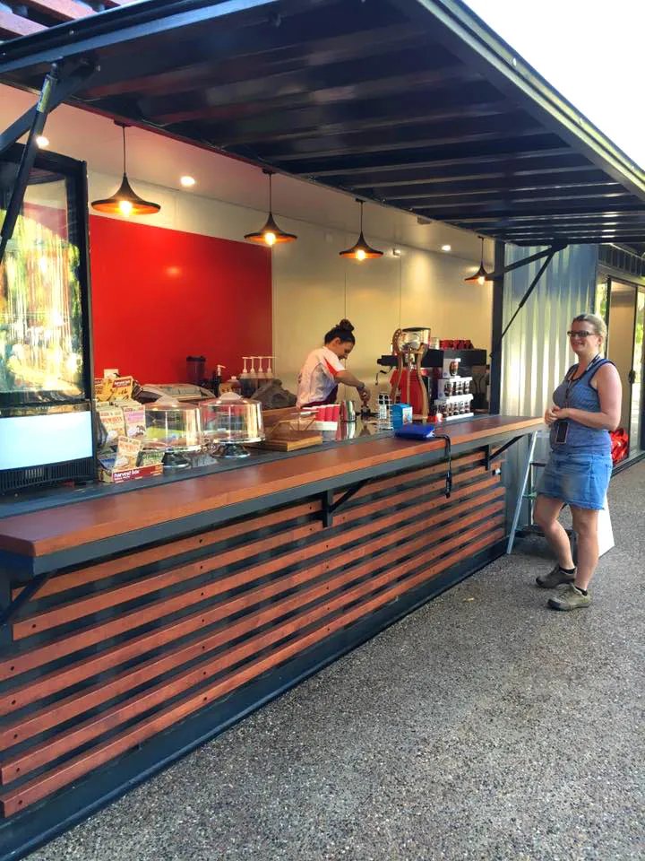 Shipping Container Kitchen – Insulated, Lockable – Counter perspective of a container cafe with staff member and display items