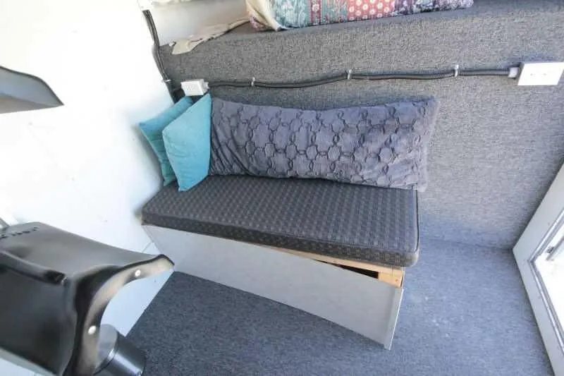 1999 Sundowner 20 ft Horse Trailer – Weekender – Small padded bench seat with pillows inside the trailer living area