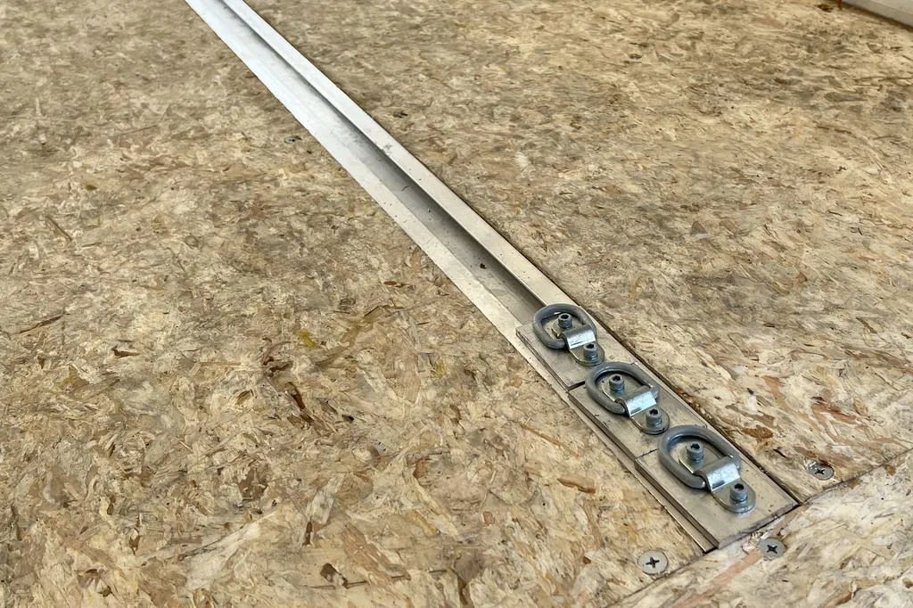 2023 High Country 14 ft Trailer – Blue, Drive-Through – Metal recessed slide track with D-ring tie-down points on the wooden floor