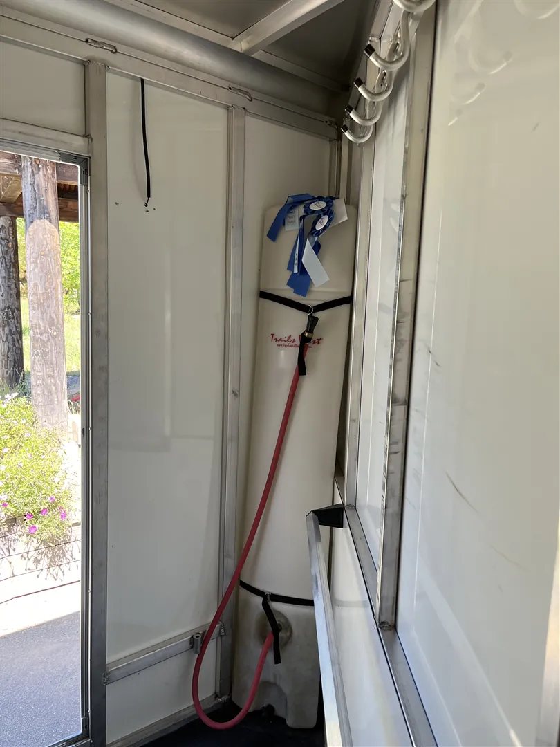 2013 Sundowner Sportsman 3 Horse Trailer – Extra-Large Tack Room – A water tank and bridle hooks inside the front tack room area