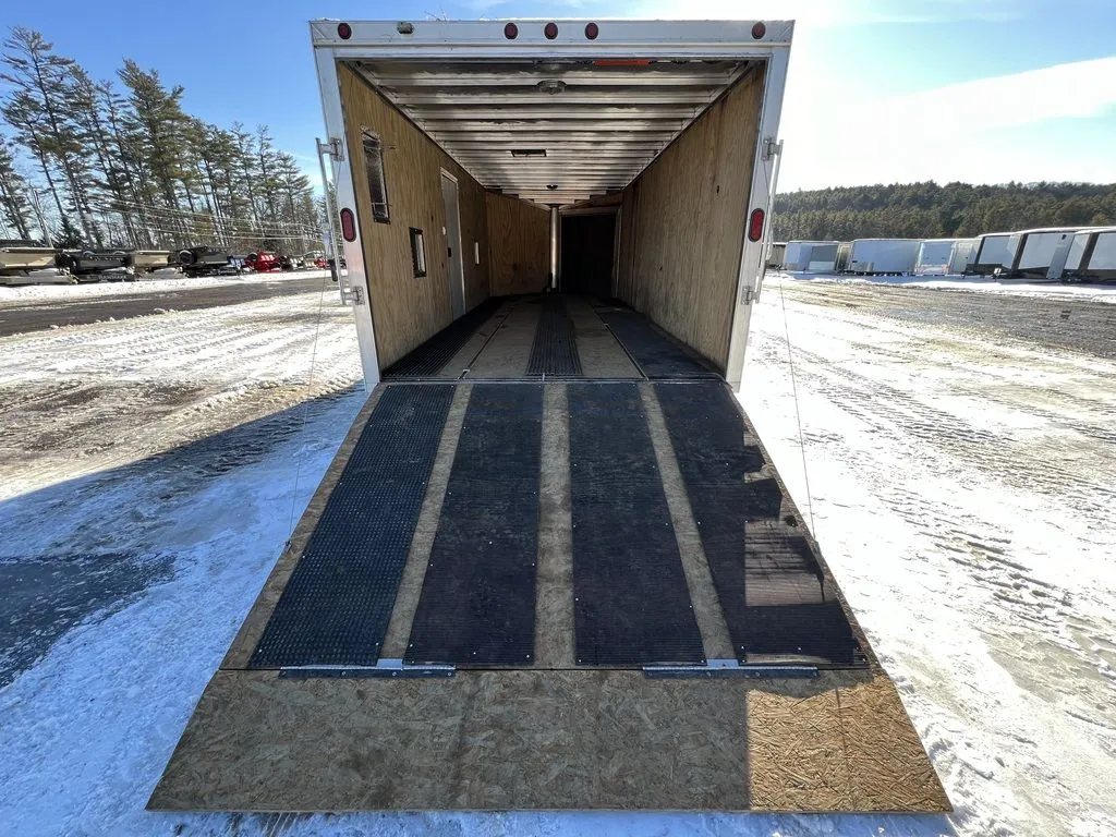 2008 Sno Pro 4-Place Snowmobile Trailer – Black Aluminum – Perspective from the ground looking up the ramp into the trailer