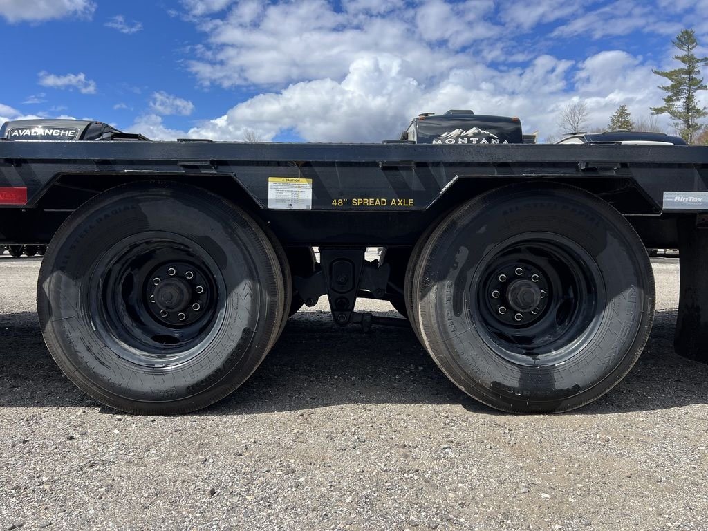 2023 Big Tex 40 ft Equipment Trailer – Slide-Out Ramps – Close-up view of the dual spread axle system and heavy-duty black wheels
