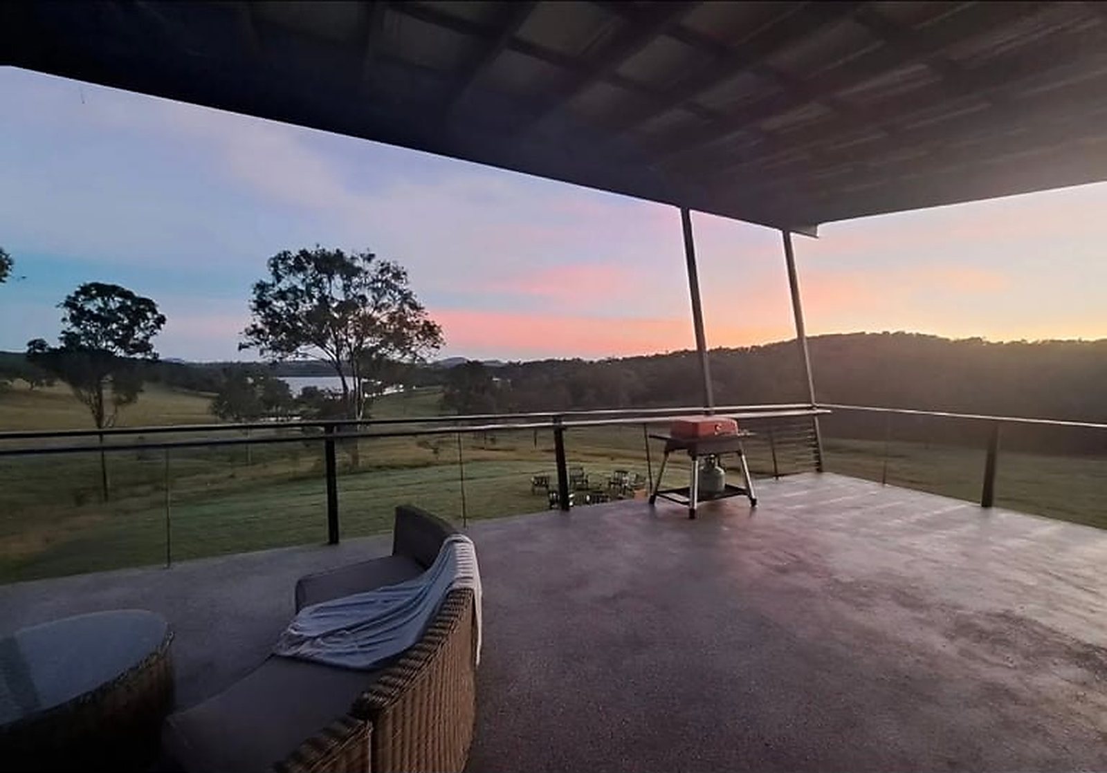 3-Bedroom Two-Story Container Home – Upper Terrace & Patio – Sunset from the upper terrace — 360-degree views over the surrounding valley