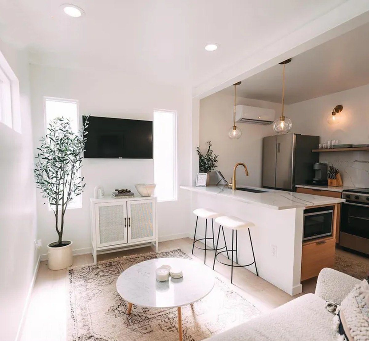 3-Bedroom Duplex Container Home – Rooftop Deck – Open-plan living and kitchen zone with mini-split cooling and hardwood-look floors