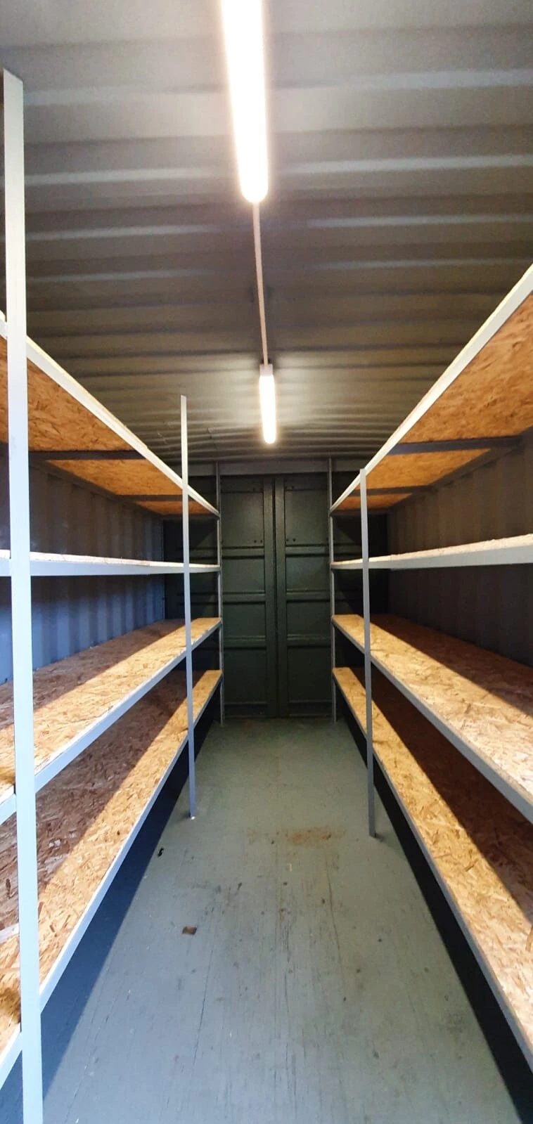 20ft High Cube Storage Container – Lighting and Shelving – container interior with wooden shelving and overhead strip lighting (8)