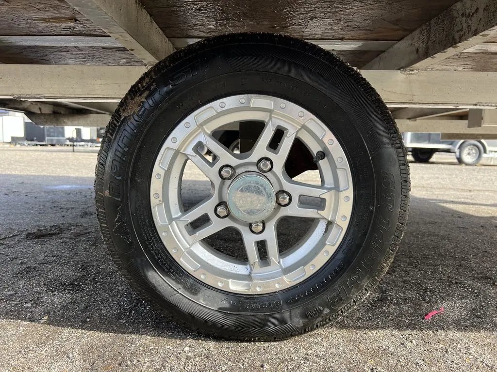 2021 Mission Trailers 2-Place Hybrid – Blackout Package – Close-up view of the trailer wheel and aluminum rim from underneath