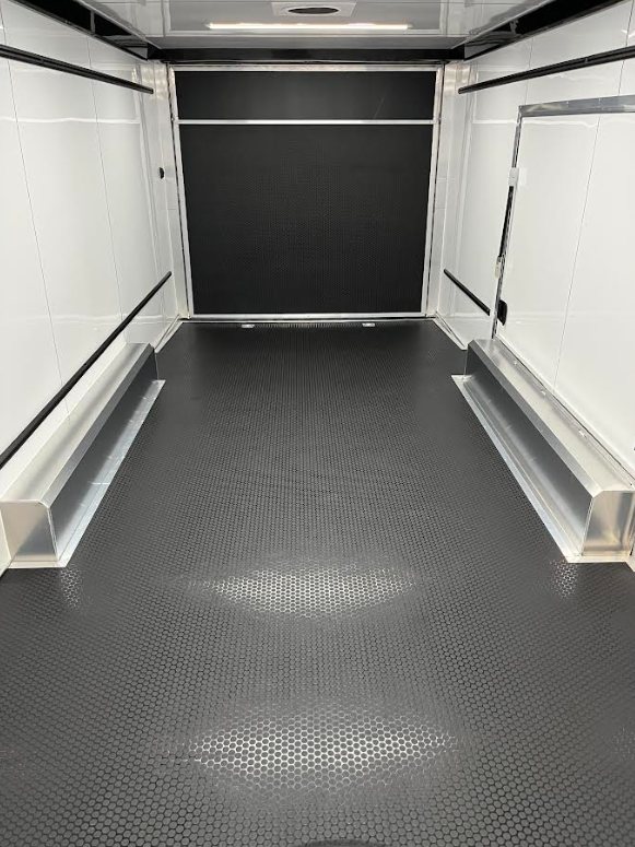 2026 ATC 24 ft ROM 550 – Lithium Power – Interior view looking towards the rear ramp door with black flooring and white walls