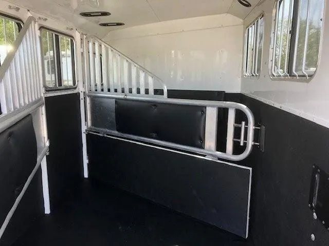 2010 Merhow 3 Horse Bumper Pull Trailer – Rear Ramp – Empty horse trailer interior with metal dividers and black padded walls