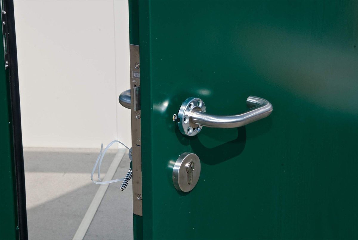 Flat Pack Office – Insulated Panels, Pre-Wired Electrical – close-up of green door with silver handle and lock