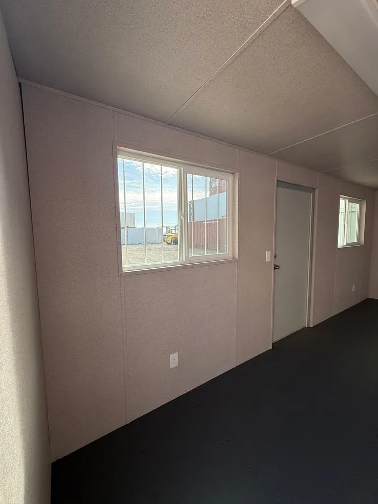 20ft Ground-Level Office Container – Insulated Workspace – empty office interior with two windows and entry door
