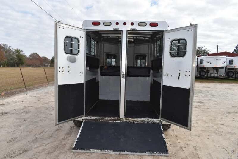 2001 CM Odyssey 2 Horse Trailer – Aluminum Floor – Rear view looking into the horse stall area with the doors fully open