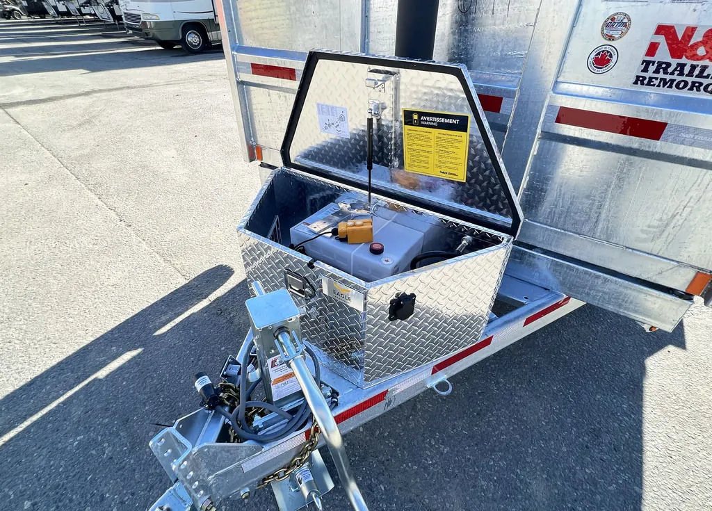 2024 N&N Trailers 14 ft Dump – Galvanized Steel – Open diamond plate storage box showing the battery and hydraulic pump system