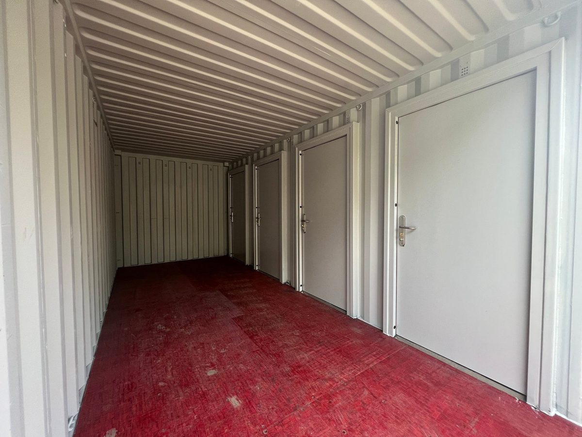20ft New Shipping Container – Four-Door Storage Configuration – Empty container interior with four storage doors and red floor