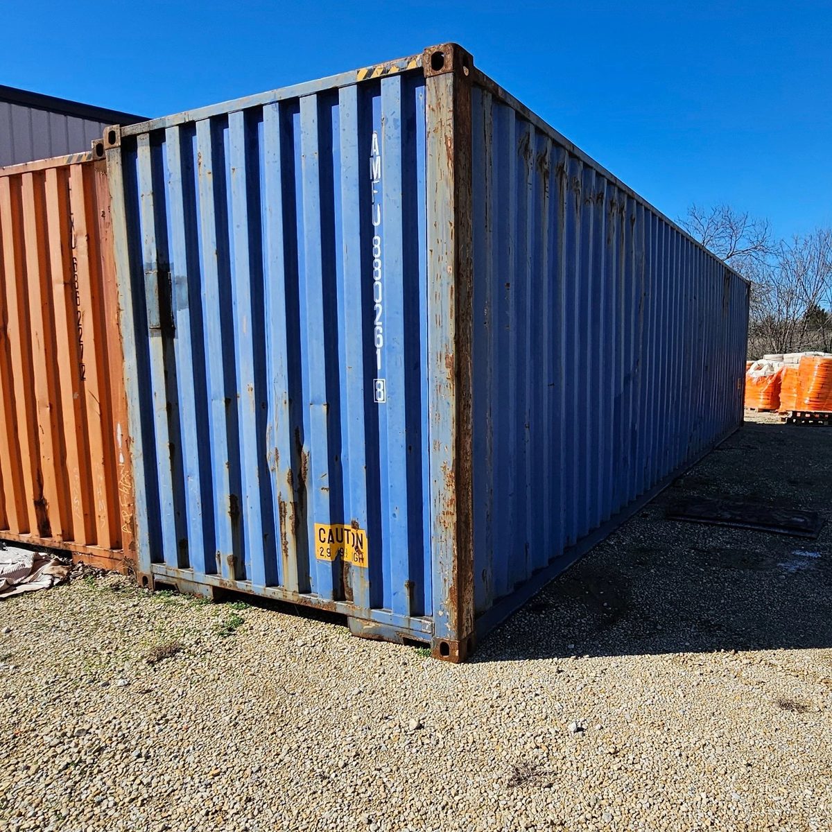 40ft High Cube Shipping Container – Used, Wind & Watertight – Three-quarter exterior view of weathered container with solid end visible
