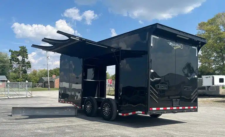 2026 Haulmark 20 ft Car Trailer – Large Escape Door – Black enclosed car trailer with large side escape door open in a lot