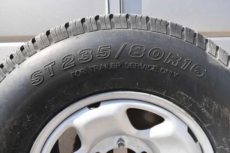 2010 Calico 2 Horse Trailer – Steel, Walk-In Dressing Room – Close-up view of the tire showing the size specifications and tread pattern