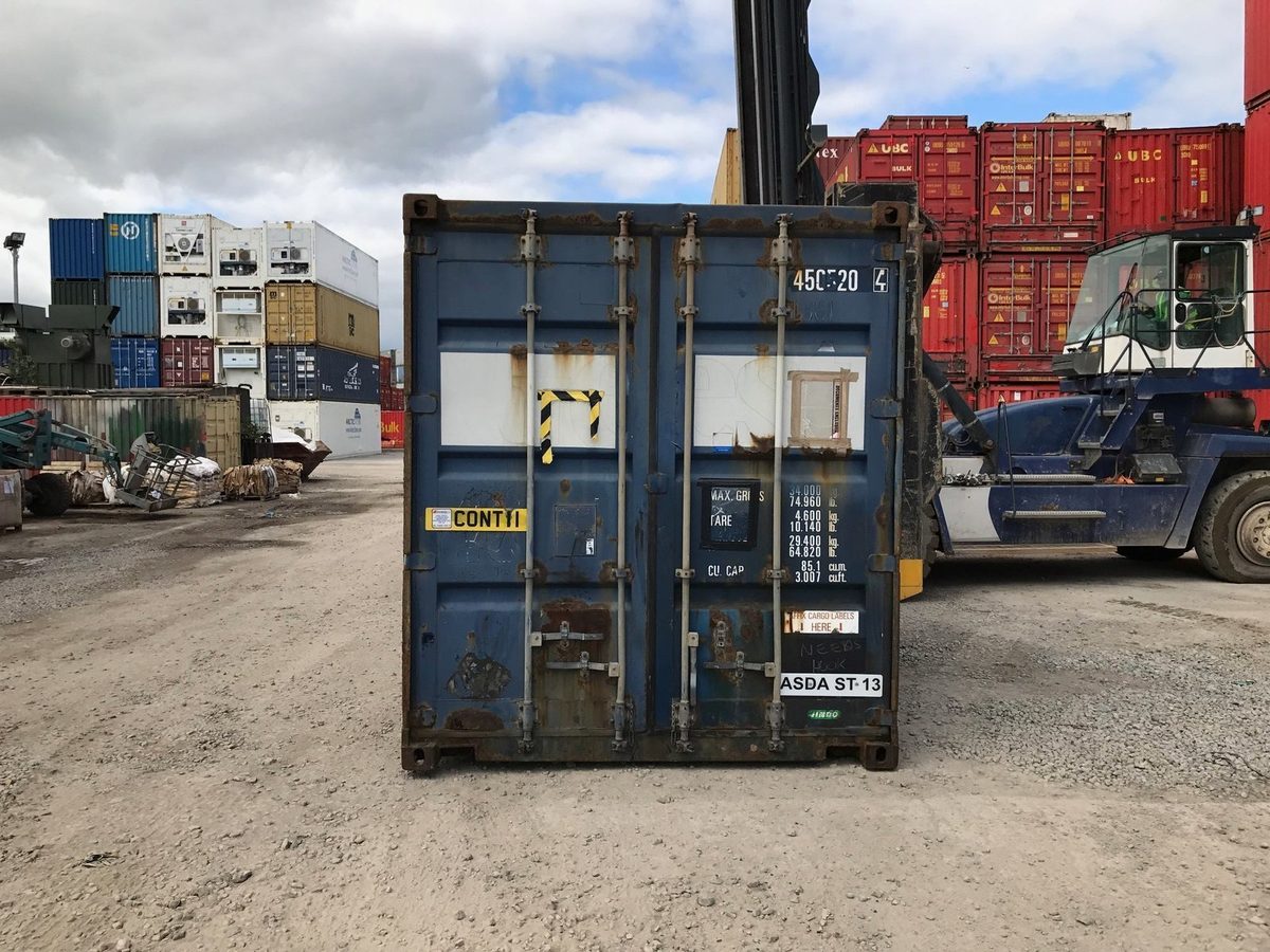 45ft High Cube Shipping Container – Used, Large-Capacity Storage – closed blue container doors in a cluttered shipping yard