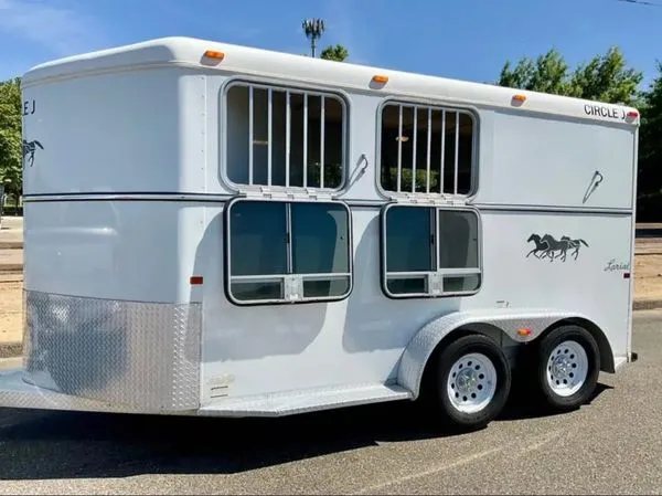 2007 Circle J 2 Horse Trailer – Slant Load – Left side view of trailer with drop-down windows open showing bars
