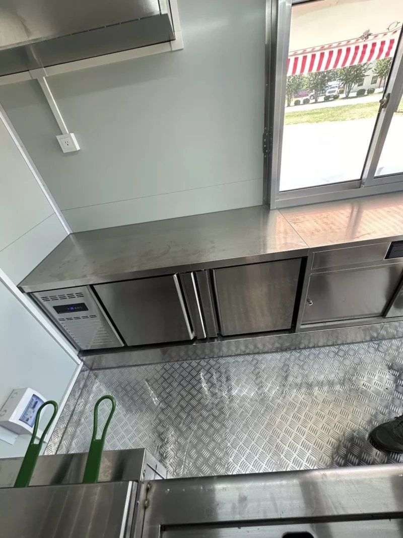 14 ft Food Trailer – Red Finish – Stainless steel work surface and cabinets next to the service window