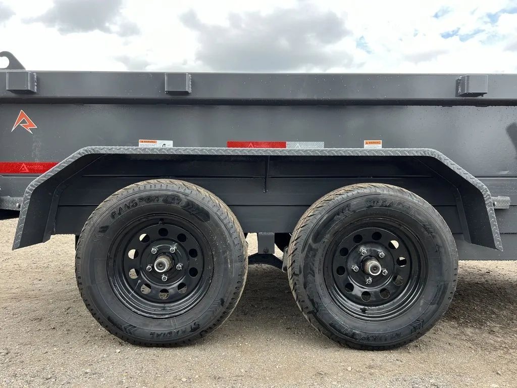 2024 RawMaxx 10 ft Dump Trailer – Shadow Grey – Close-up shot of the dual axles and black wheels under the trailer fender