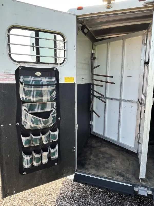 2004 Sundowner 3 Horse Trailer – Weekender Living Quarters – Rear tack storage area with saddle racks and a door-mounted organizer bag