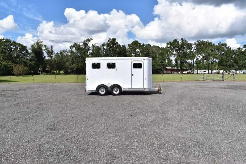 2002 Exiss SS20 2 Horse Trailer – Walk-Through Dressing Room – Wide shot of the trailer parked in an open lot with trees behind