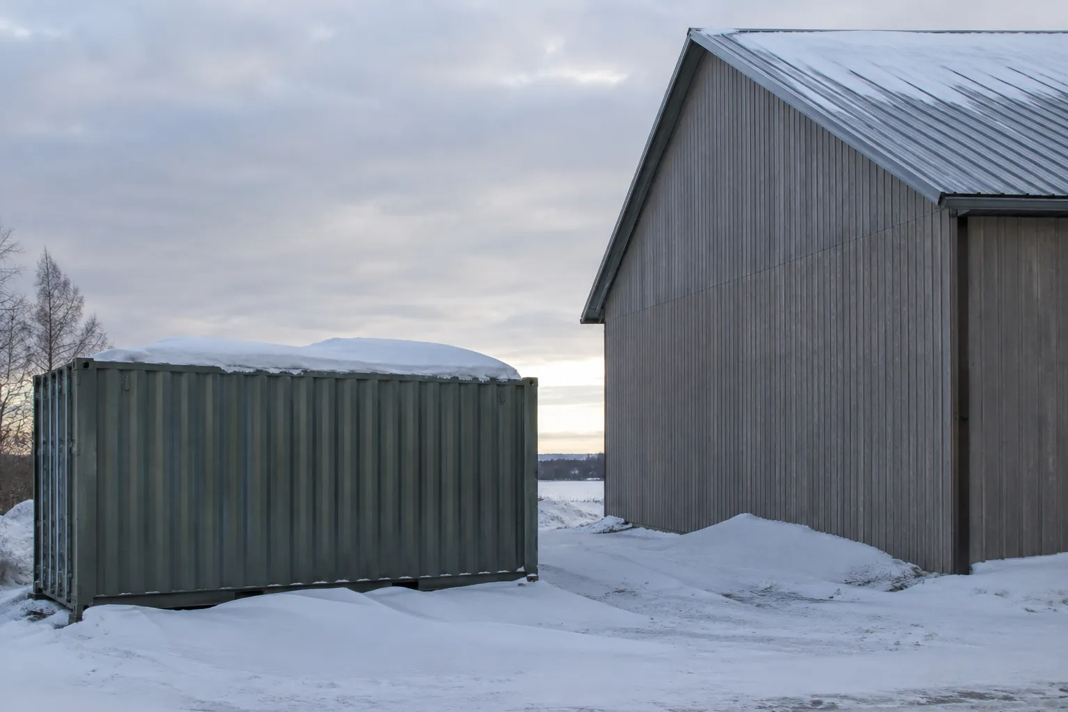 Nearby sloped building roof creates additional shipping container snow load assessment considerations