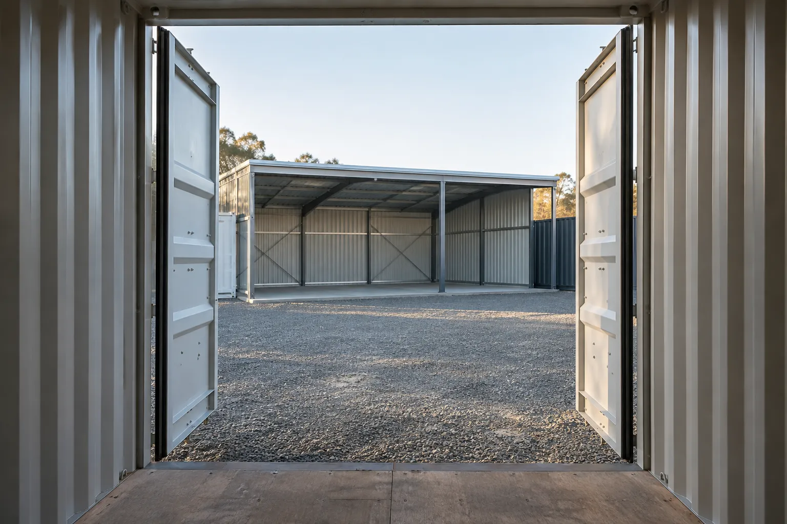 Open cargo doors beside a container barn showing unobstructed equipment access.