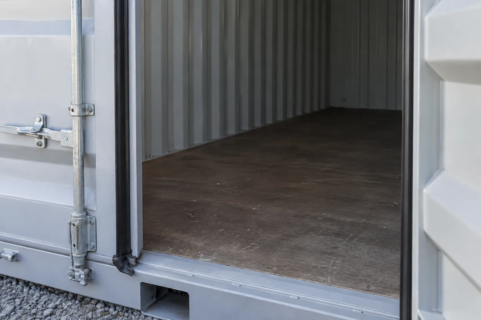 Storage container doorway showing weather seals, locking hardware and floor threshold