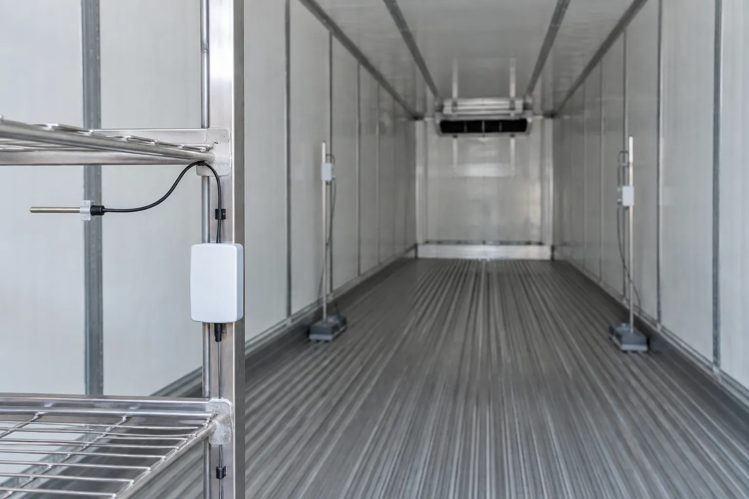 Temperature probes inside an empty refrigerated shipping container during preloading performance testing.
